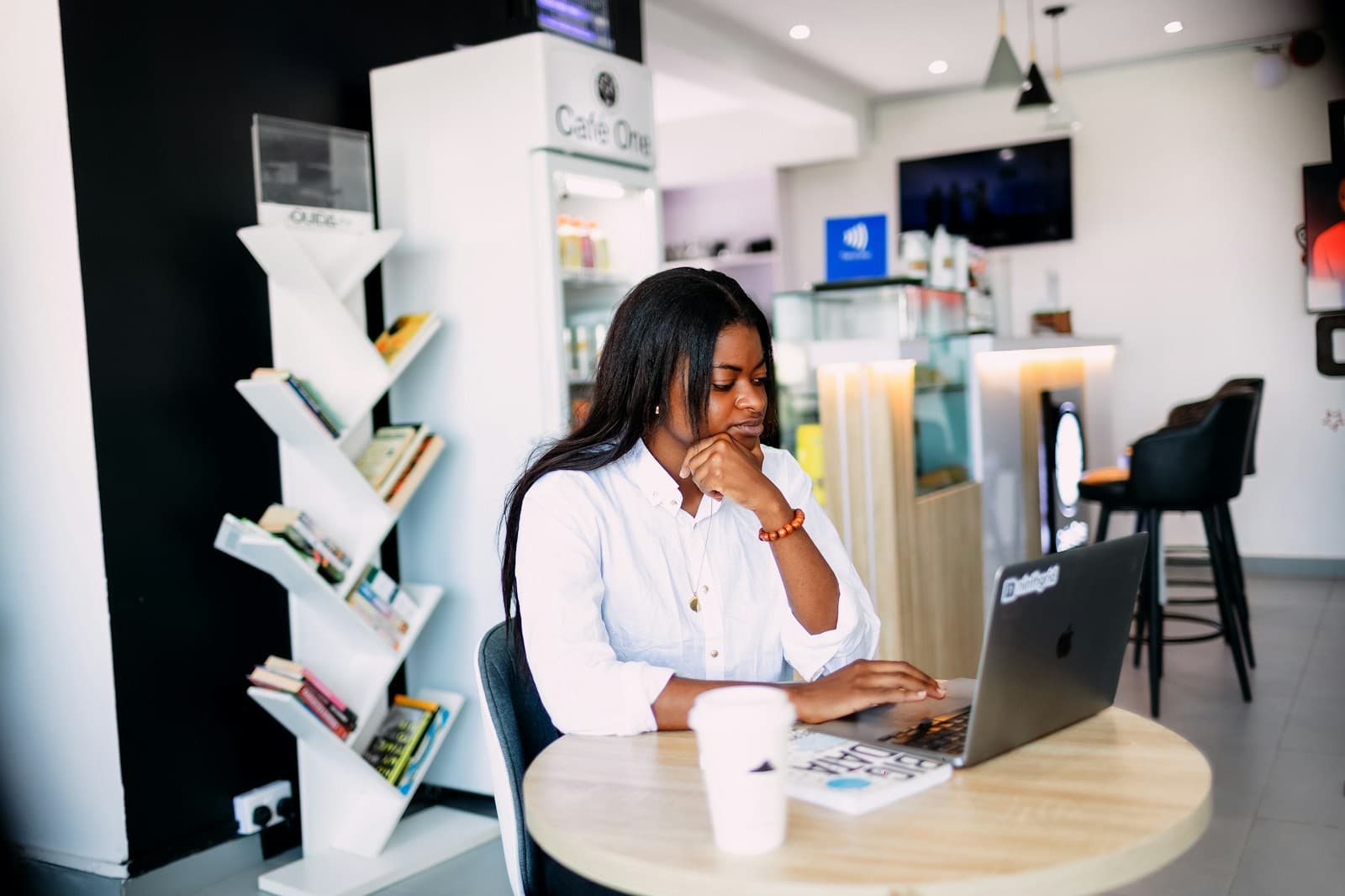 A developer working on her laptop in a café